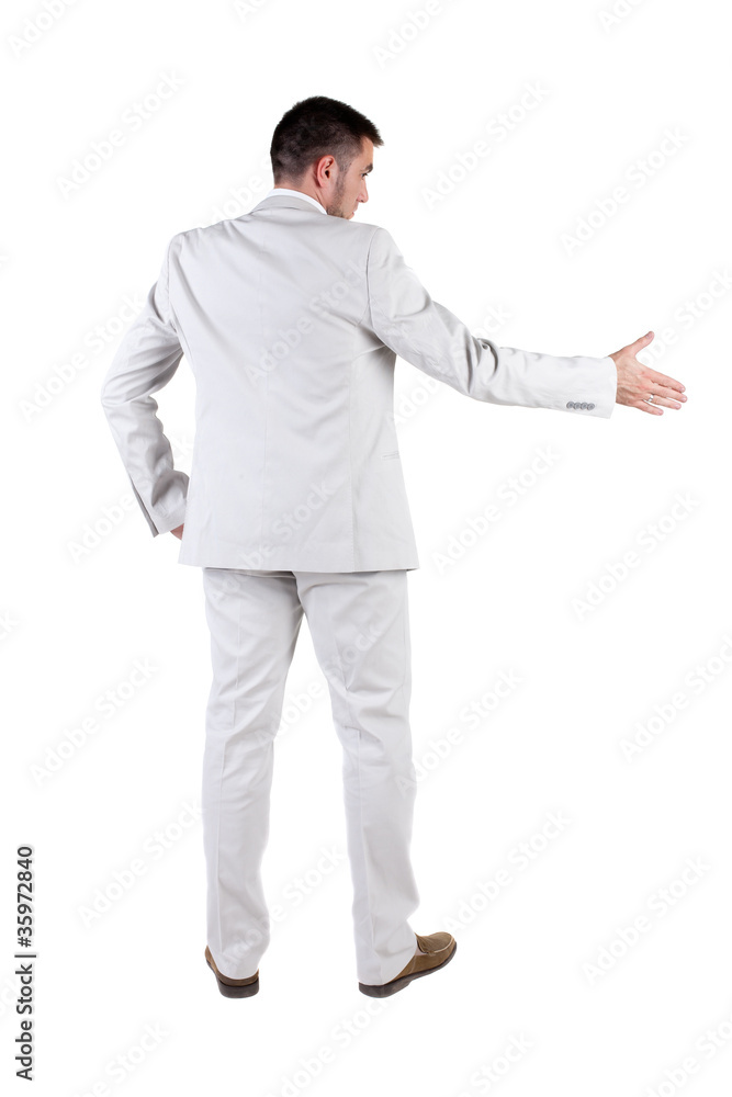 businessman extending hand to shake. Rear view. businessman extending hand to shake. Rear view.
