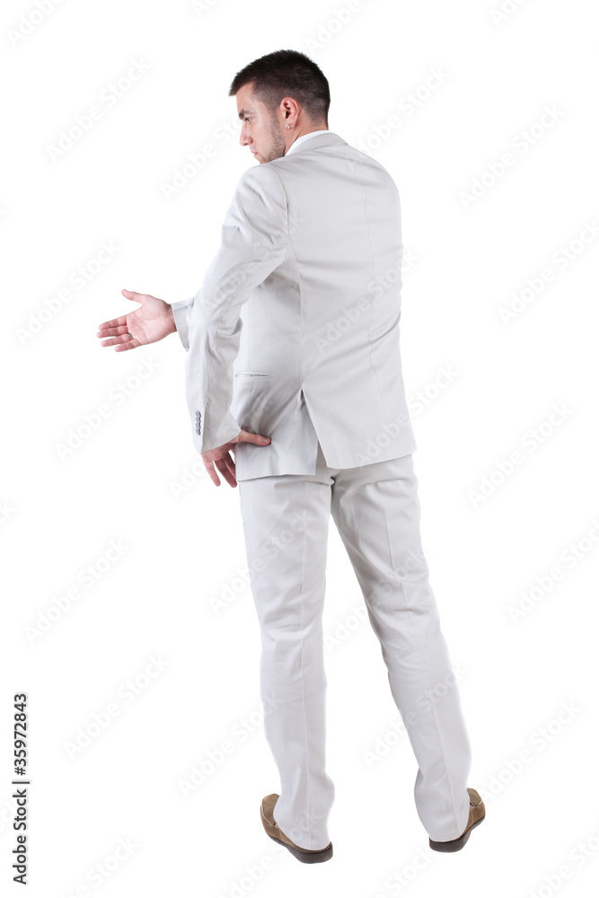 businessman extending hand to shake. Rear view.