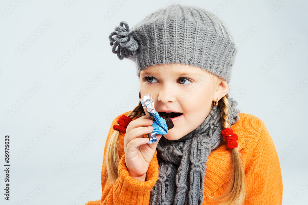 Lovely little girl eating a candy Lovely little girl eating a candy