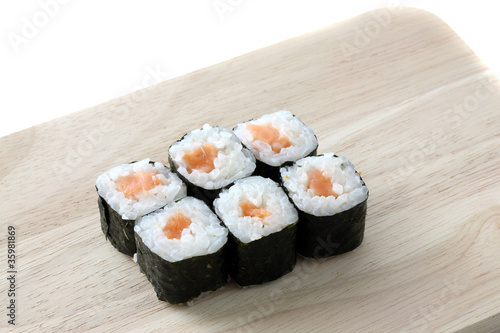Salmon Maki sushi on wood isolated in white background