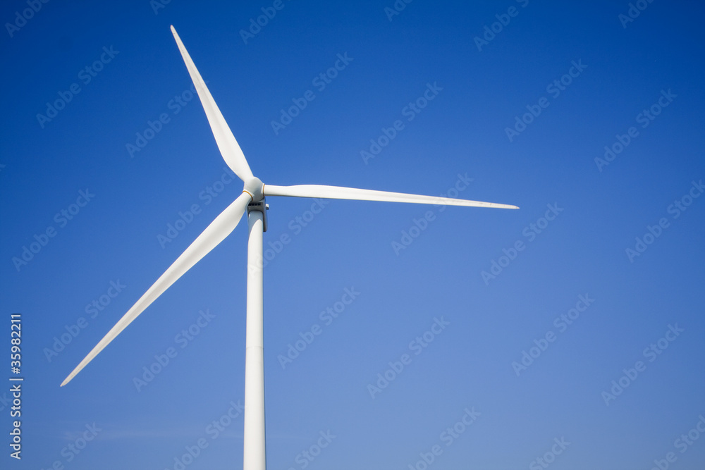 white wind turbine generating electricity on blue sky white wind turbine generating electricity on blue sky