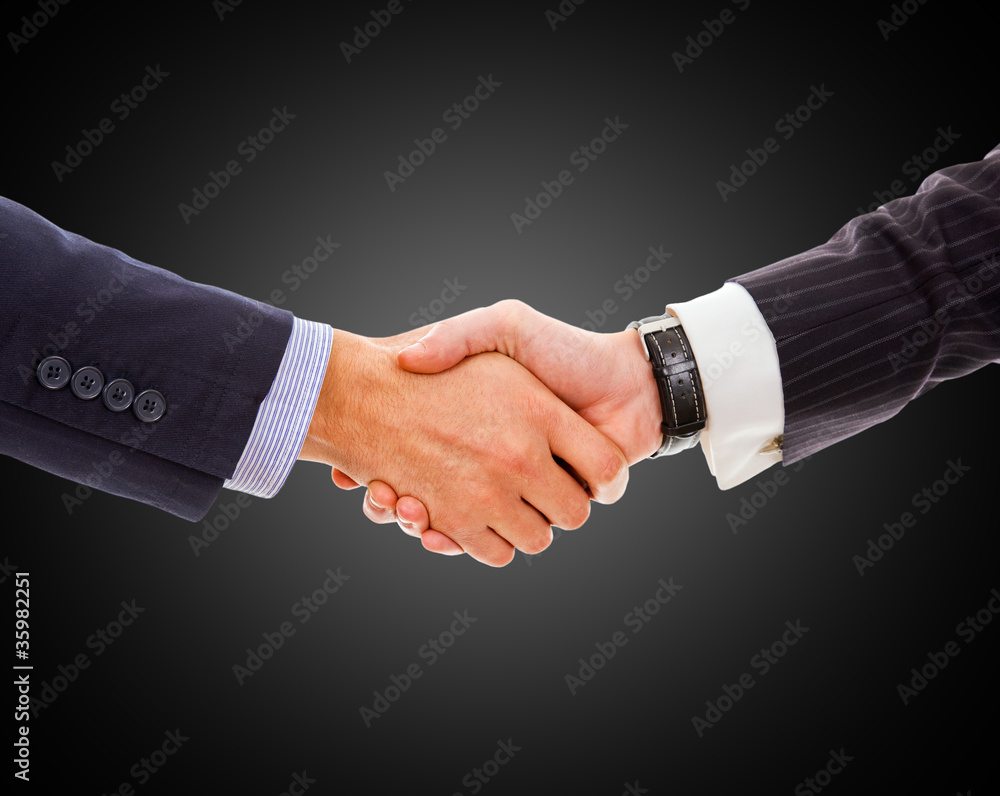 Handshake - Hand holding on black background Handshake - Hand holding on black background