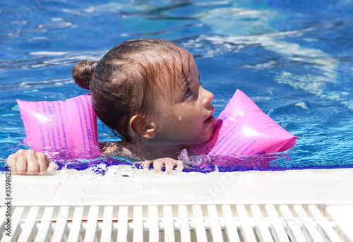 Schilderij op canvas Little girl swimming in pool