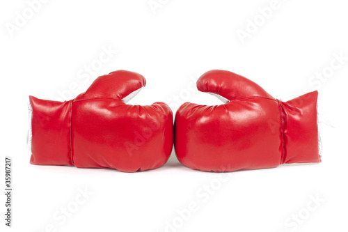 Red boxing leather gloves isolated on white. © Xtremest