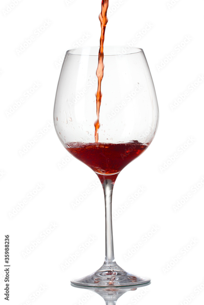 Red wine pouring into glass isolated on white Red wine pouring into glass isolated on white