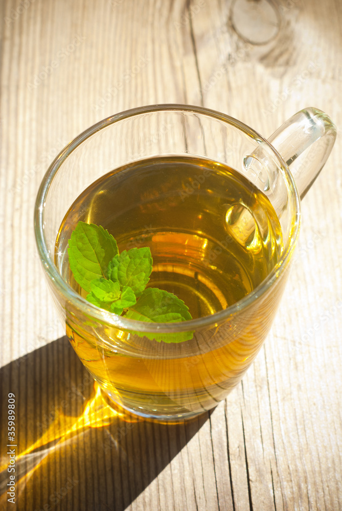 mint tea and mint leaf on old wooden table mint tea and mint leaf on old wooden table