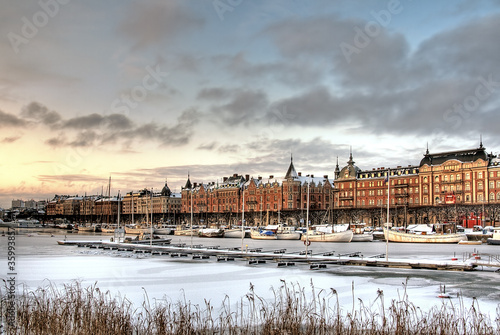 Canal with boats in the city in winter.