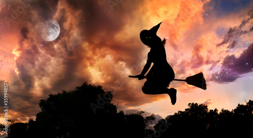 Flying witch on broomstick photo