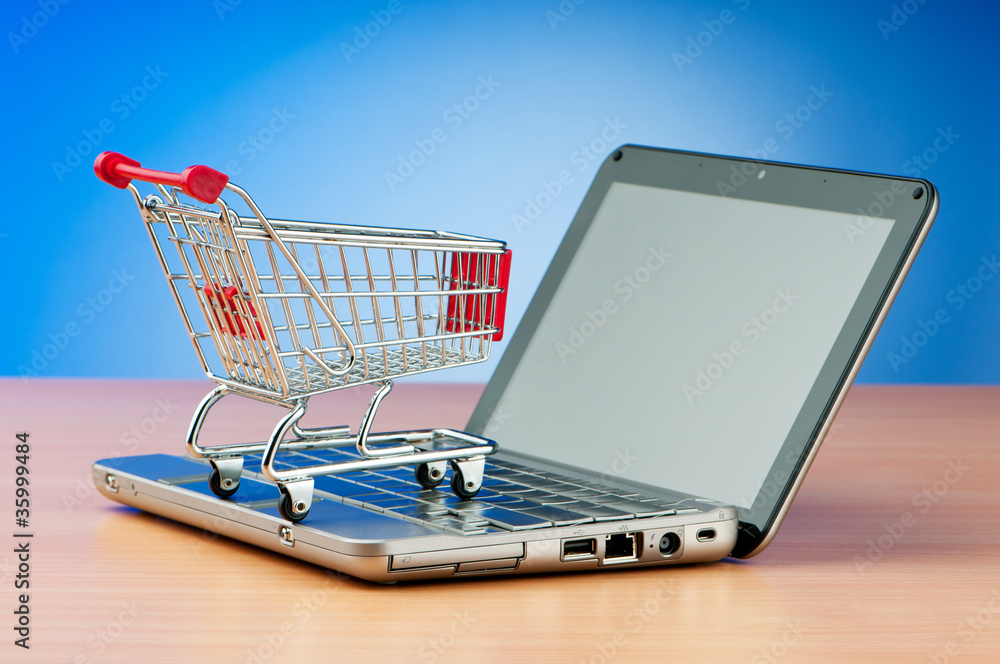 Internet online shopping concept with computer and cart Internet online shopping concept with computer and cart