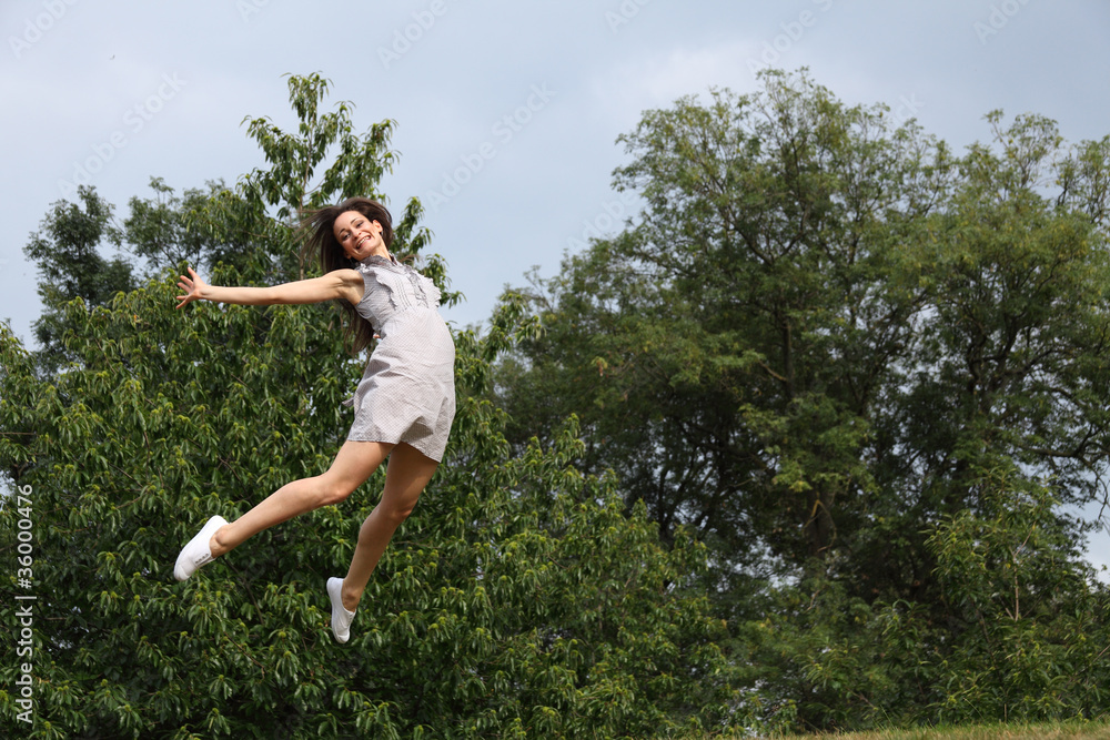 High jump in trees for success of beautiful girl High jump in trees for success of beautiful girl