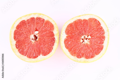 Grapefruit cut in half on white background