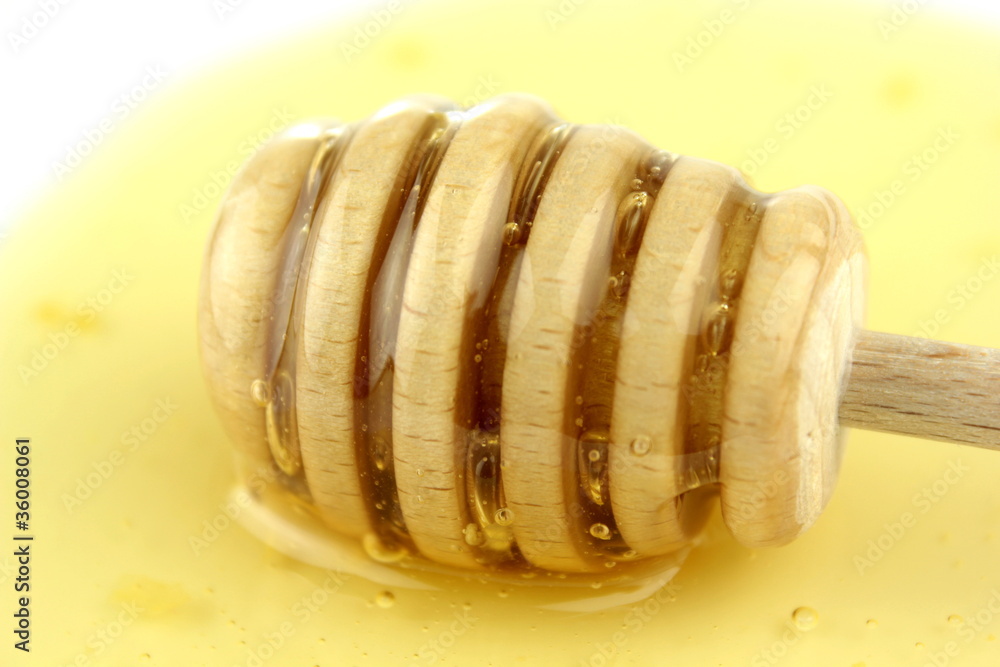 Honey and wood honey spoon - macro Honey and wood honey spoon - macro