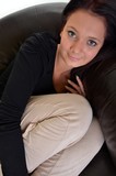 Portrait of attractive young female sitiing on sofa