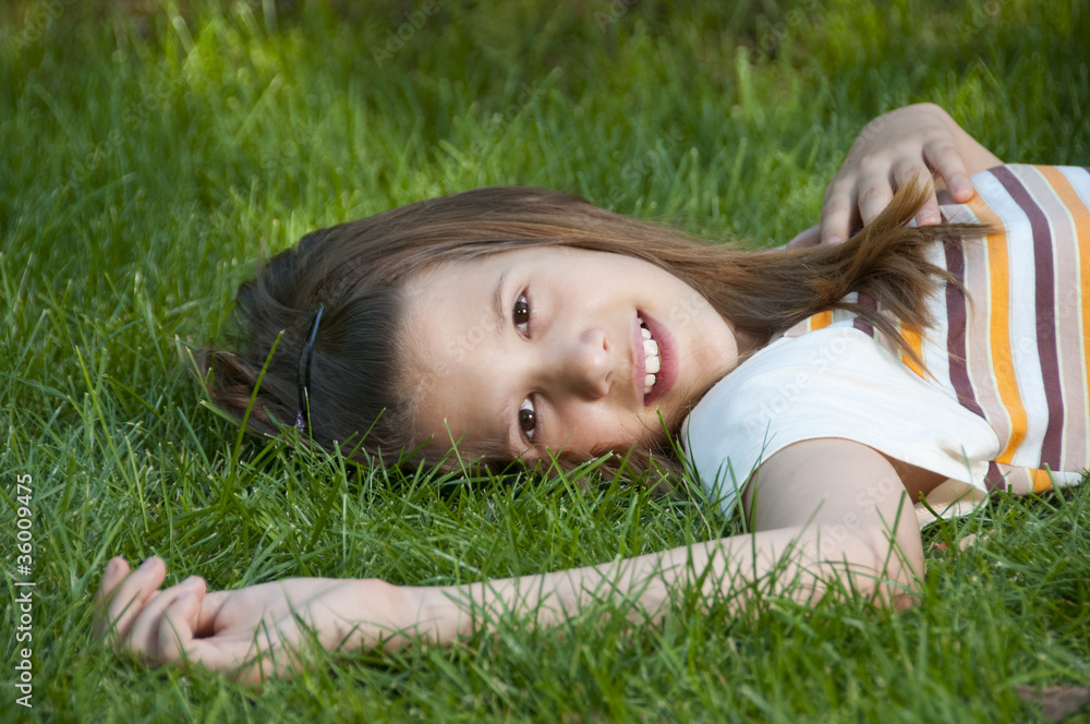 Pretty young teenage girl resting on the bed of grass Pretty young teenage girl resting on the bed of grass