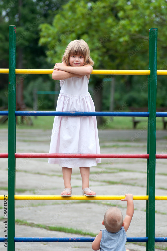 Brother and sister playing on the playground. Brother and sister playing on the playground.