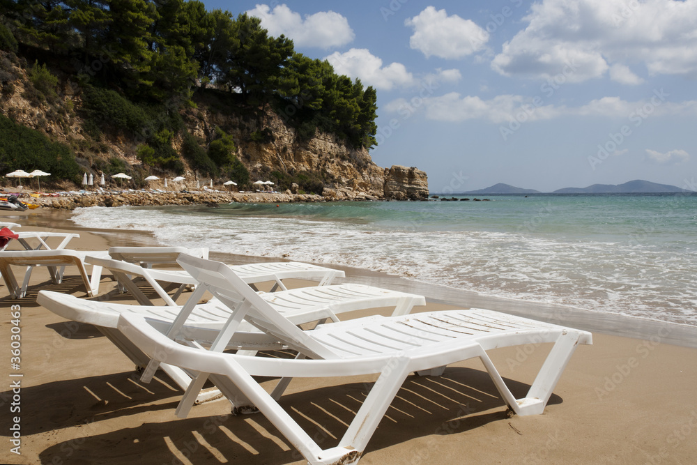 Alonissos - Beach chairs on sandy beach.