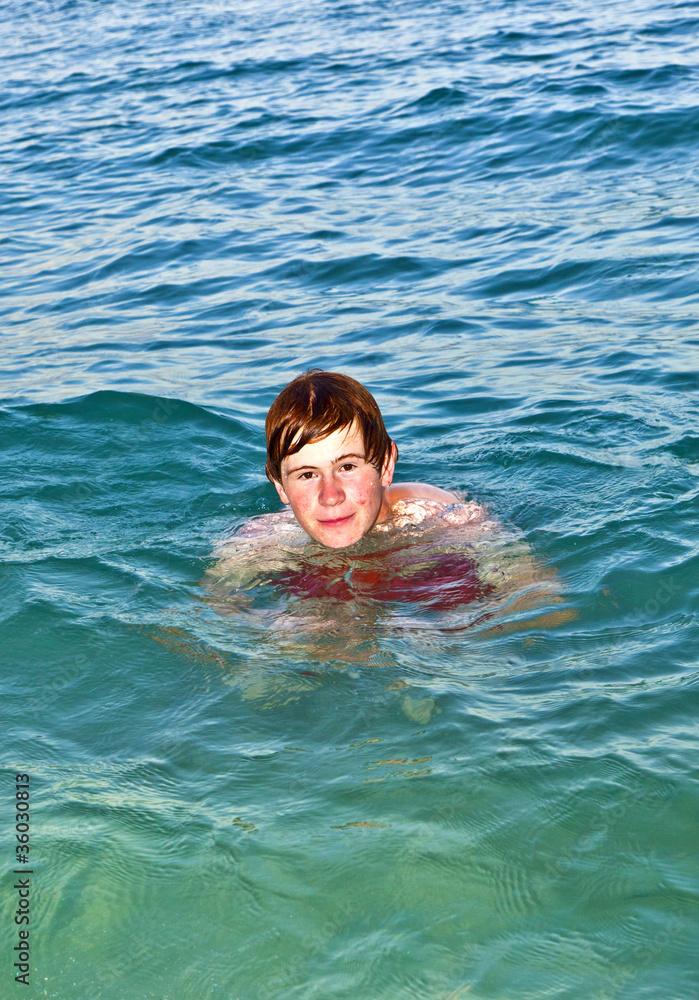 boy enjoys the beautiful water of the ocean