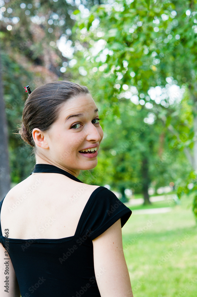 beautiful attractive young woman smiling while looking back