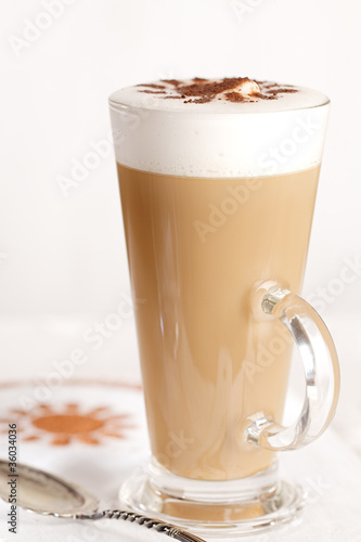 Fototapeta Naklejka Na Ścianę i Meble -  coffee latte with frothy milk in tall glass