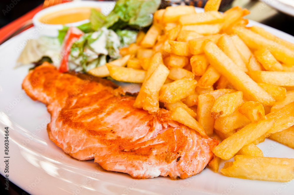 grilled salmon and lemon - french cuisine dish with tomato and s grilled salmon and lemon - french cuisine dish with tomato and s