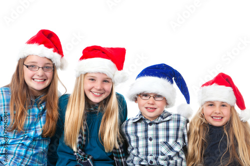 four children with christmas hats smiling
