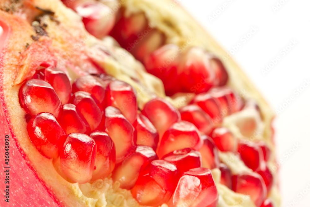 Ripe pomegranate piece isolated on white background Ripe pomegranate piece isolated on white background