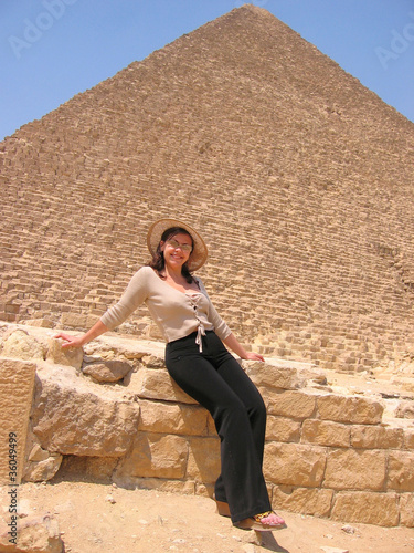 Beautiful young tourist woman near pyramid in Egypt