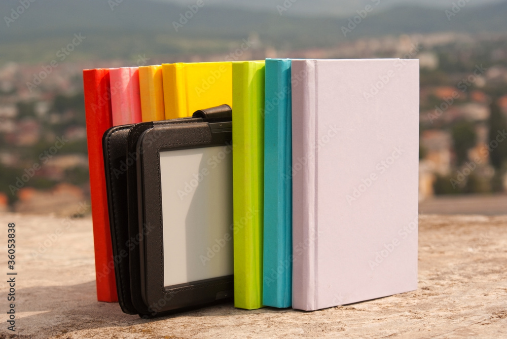 Row of colorful books with electronic book reader
