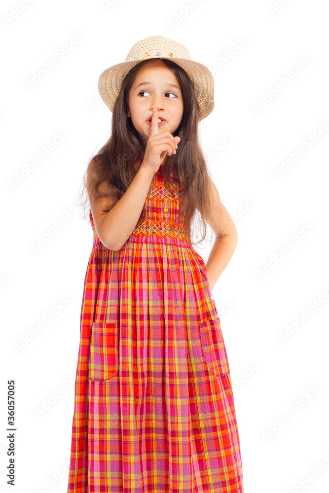 Little girl in straw showing silence sign Little girl in straw showing silence sign