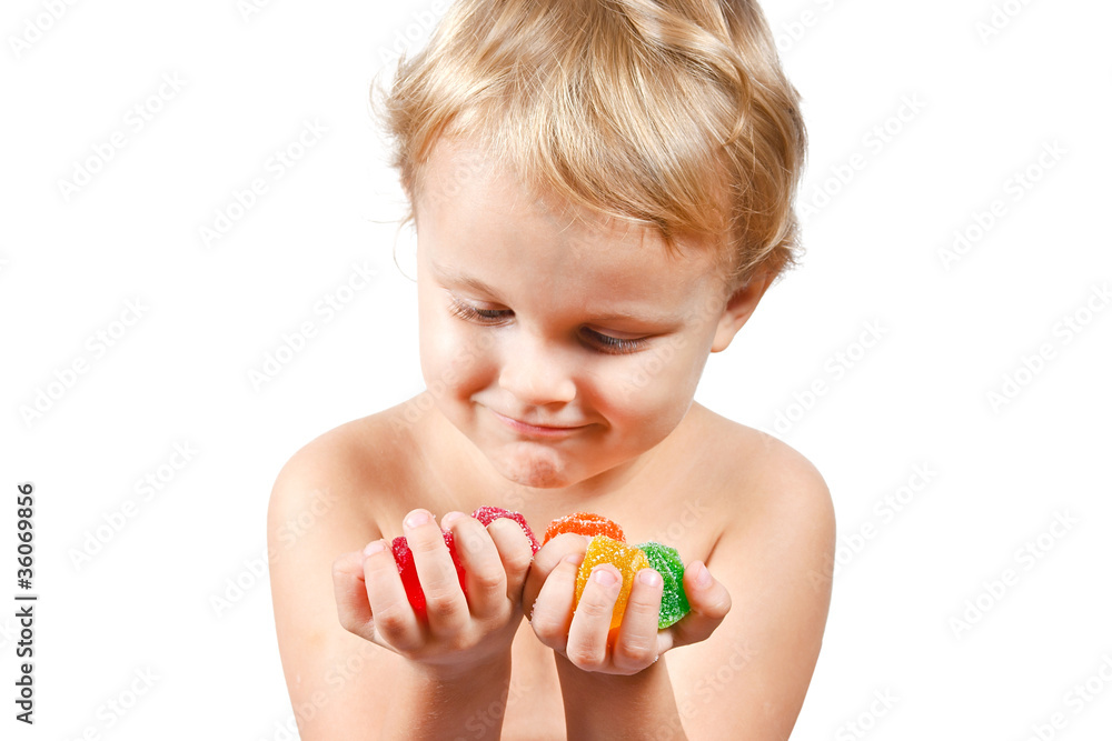 Little boy with colored jelly candies on white background Little boy with colored jelly candies on white background