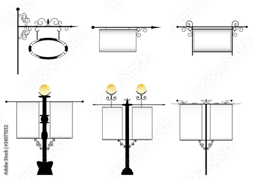 wrought-iron street lamps with a sign for advertising