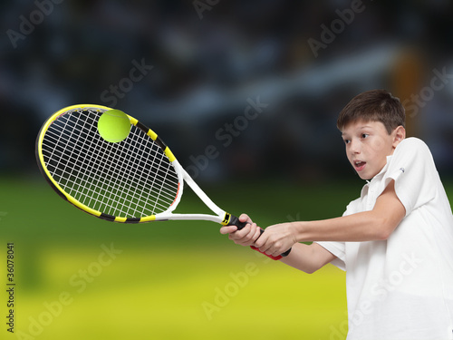 Boy plays tennis