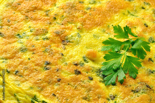 Italian omelette with parsley and parmesan cheese, closeup photo