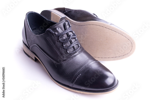 A pair of men's shoes, one on the side, isolated