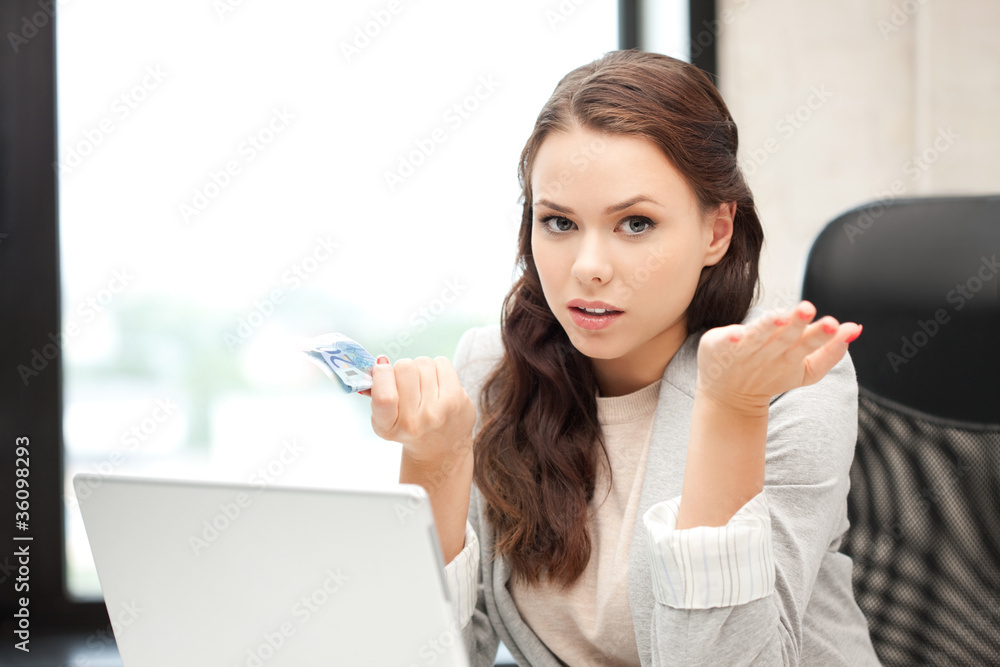 unhappy woman with computer and euro cash money unhappy woman with computer and euro cash money