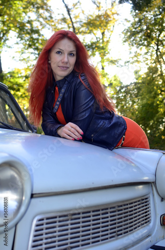 redheaded girl near the old car