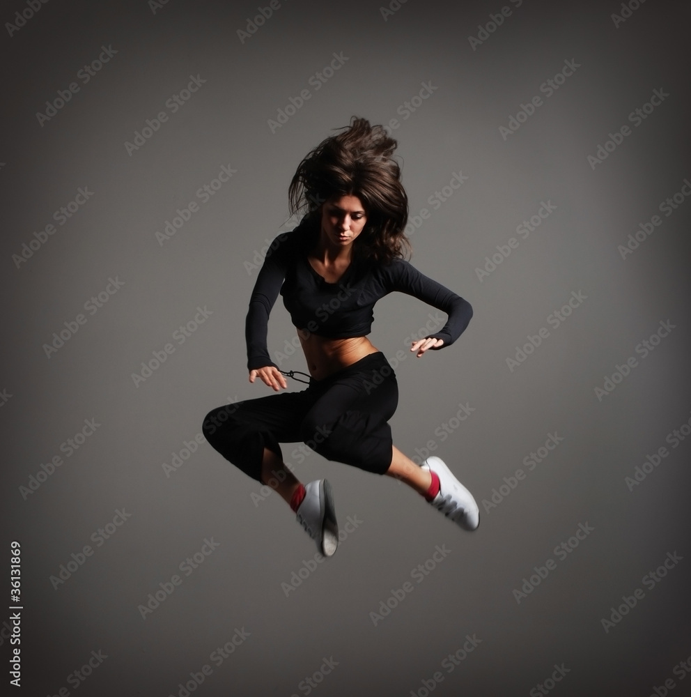 A young brunette woman caught in a beautiful jump