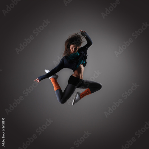 A young brunette woman caught in a beautiful jump