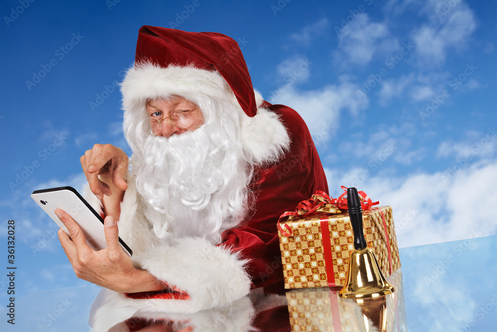 Santa Claus with tablet pc, gift and bell Santa Claus with tablet pc, gift and bell