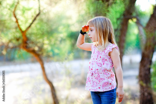 hiking kid girl searching hand in head in forest