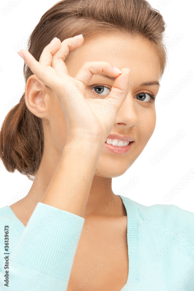 lovely woman looking through hole from fingers lovely woman looking through hole from fingers