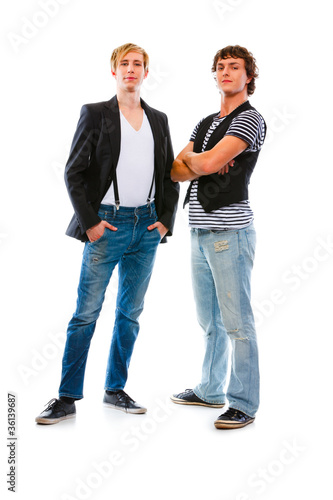 Two modern teenagers posing on white background