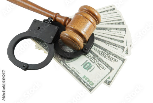 Gavel, handcuffs and money isolated on white