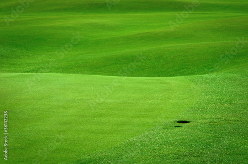 Golf background. Detail of golf field with a ball hole