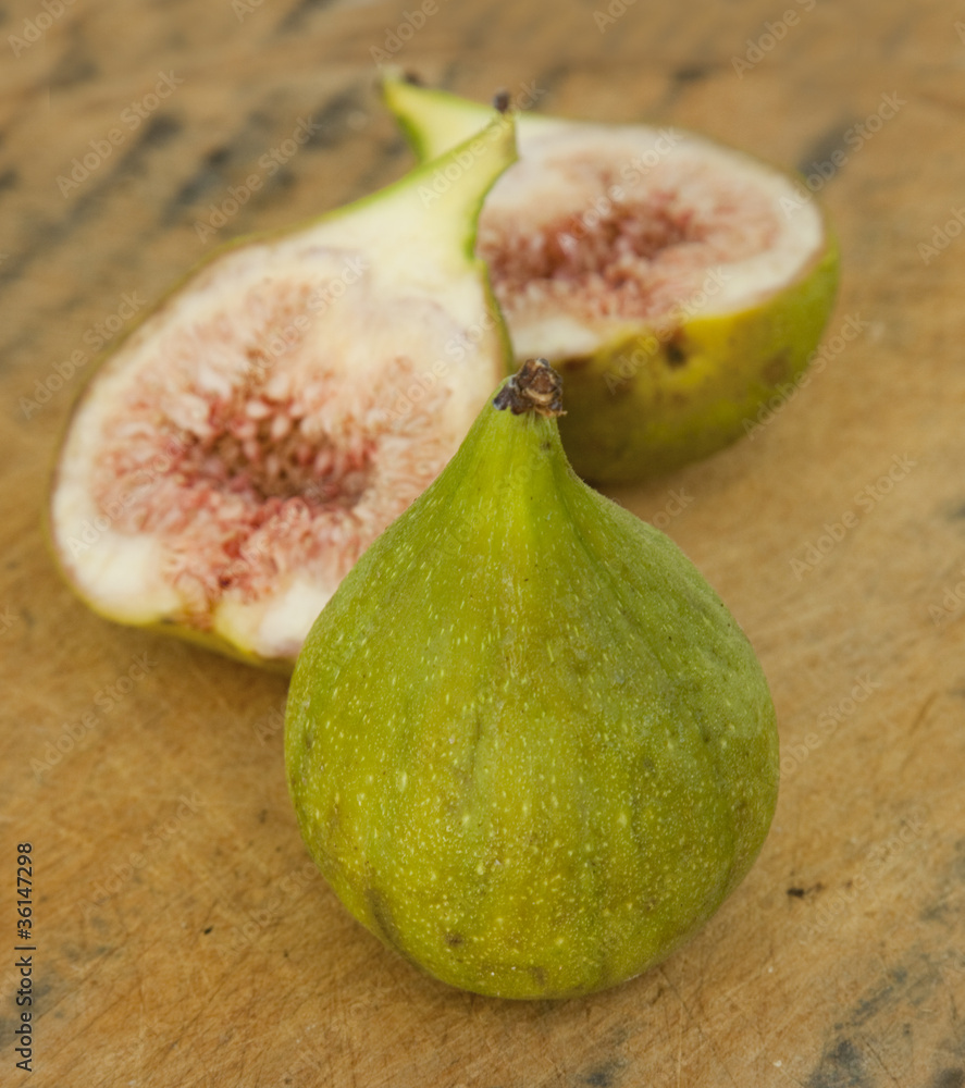 Sliced and whole fig on wood