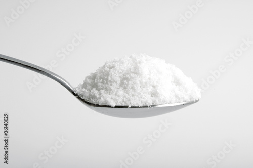 salt in the spoon on white