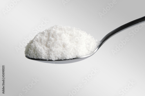 salt in the spoon on white photo