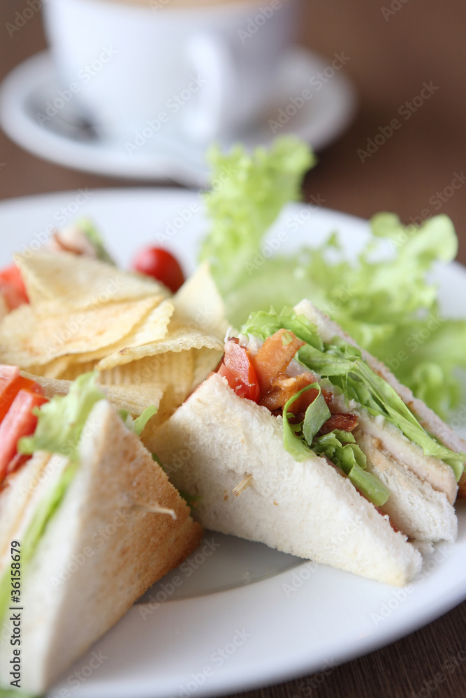 Club sandwich with coffee on wood background Club sandwich with coffee on wood background
