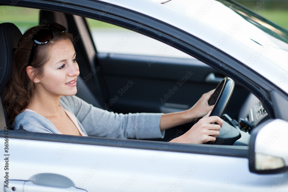 Pretty young woman driving her new car Pretty young woman driving her new car