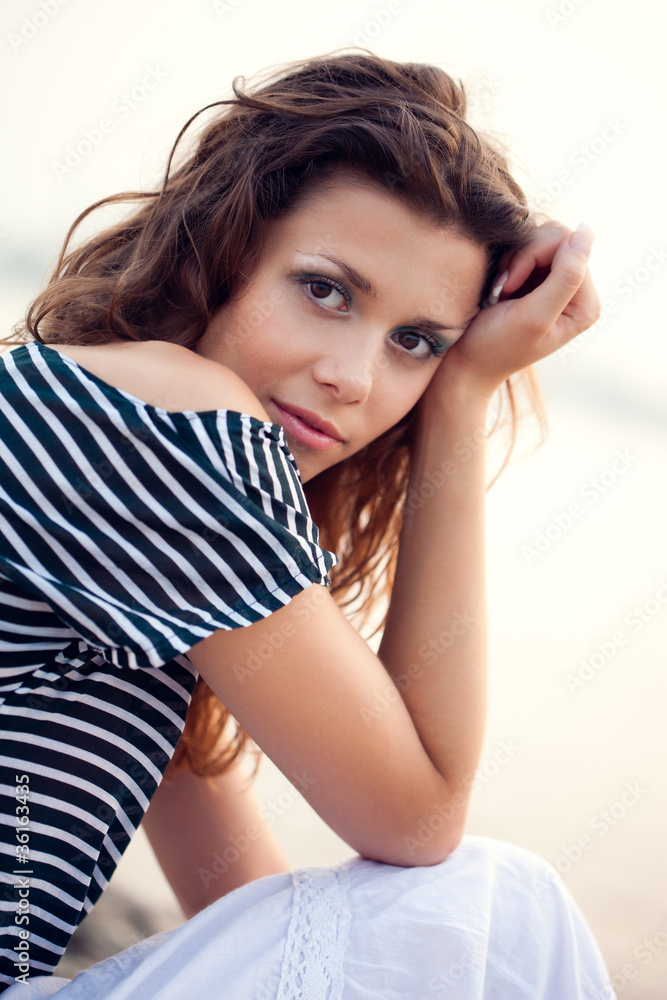 closeup woman portrait sitting on ground closeup woman portrait sitting on ground